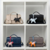 Bolsa by Ghafa All color on a shelf with angel charms